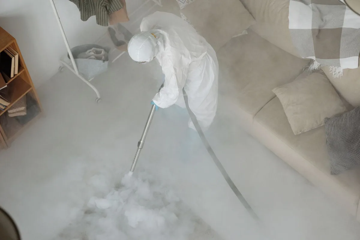 Biohazard cleanup technician in protective equipment, De Soto, KS